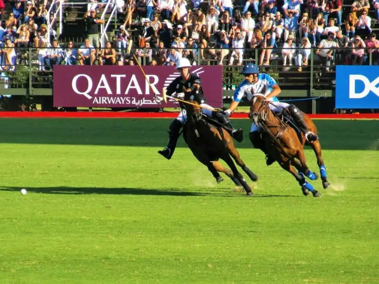 Two polo players riding during a match