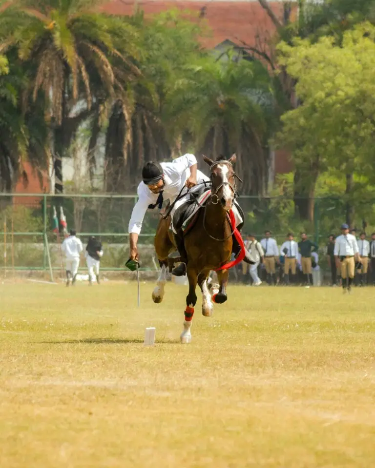 A polo player reaching for the ball